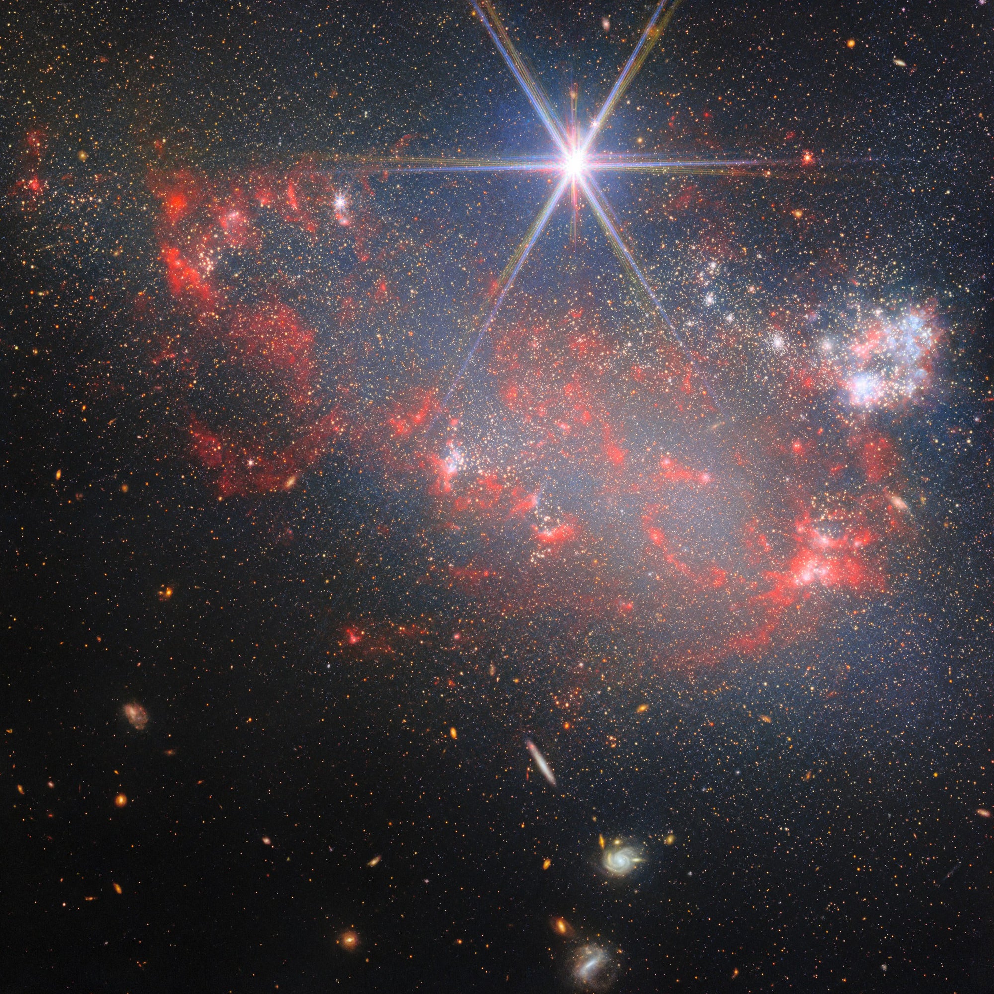 Arp 263. Irregular galaxy NGC 3239, star clusters and red dust, a spiked foreground star.
